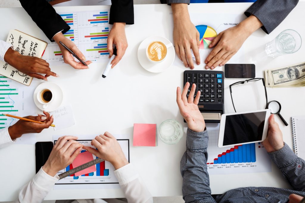 businessmen-hands-white-table-with-documents-drafts