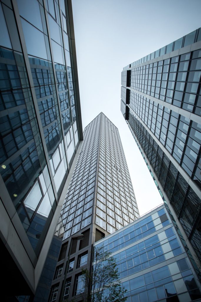 vertical-low-angle-shot-high-rise-skyscrapers-glass-facade-frankfurt-germany